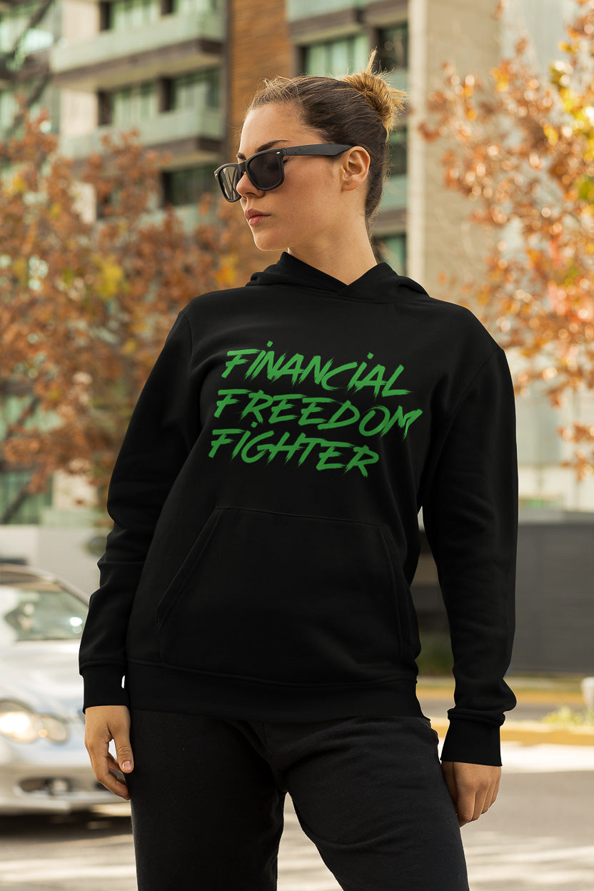 a woman showing the frontside of a black colored hoodie from the brand Stanley Stella with the inscription "Financial Freedom Fighter" in large yellow letters