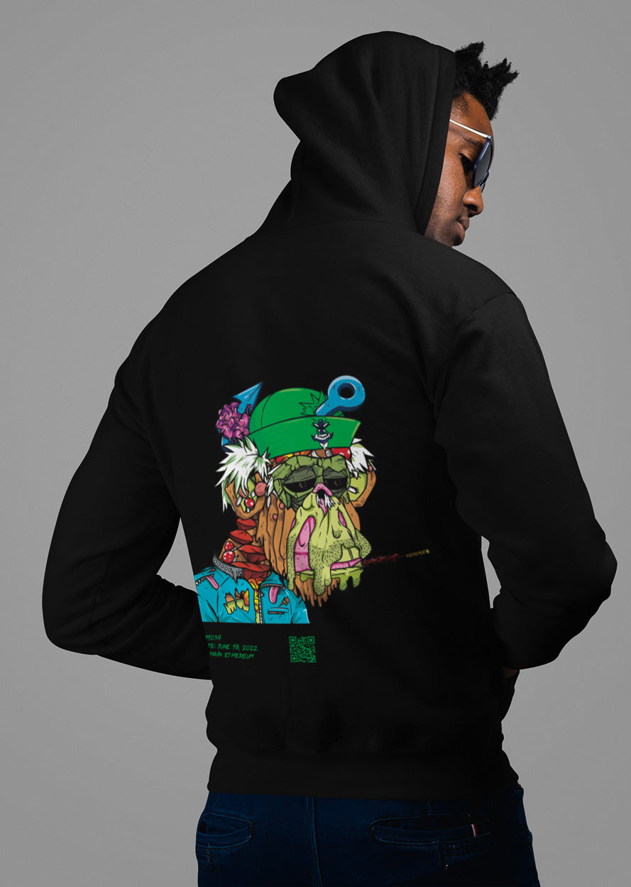 a guy showing the backside of a black colored hoodie from the brand Stanley Stella with a colorful ape print in comic style. Blockchain information under print in green letters and QR code