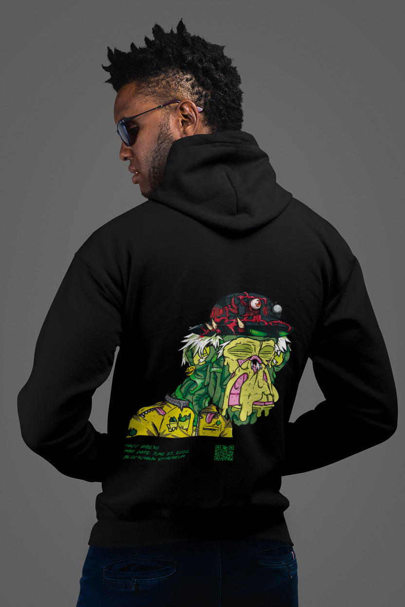 a guy showing the backside of a black colored hoodie from the brand Stanley Stella with a colorful ape print in comic style. Blockchain information under print in green letters and QR code